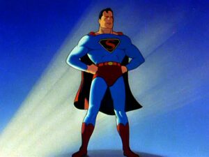 A single frame from a 1940s Superman cartoon. Partially silhouetted by light from behind against a general blue background. Superman stands with his hand on his hips, legs braced, back straight, chest out.